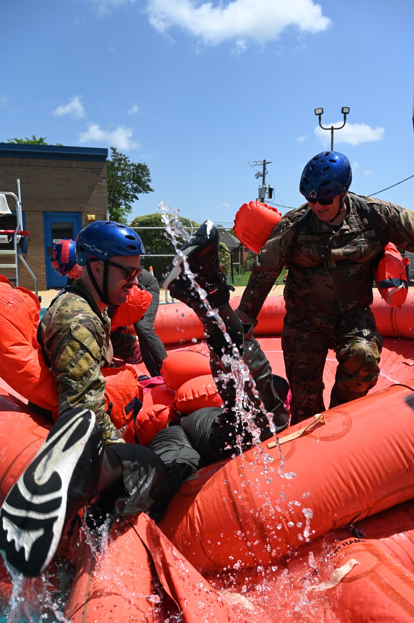 people help someone onto a life raft