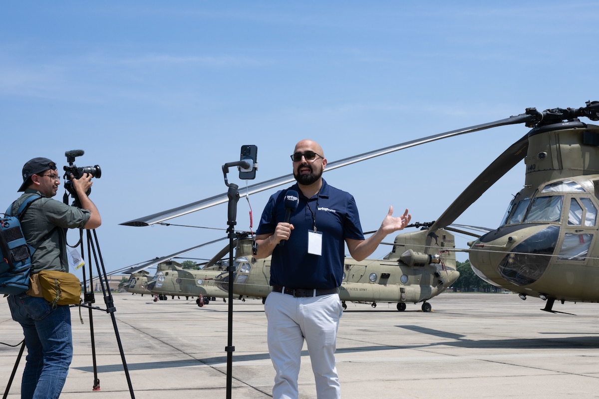 Mike Murillo films a stand-up news segment during a media engagement.