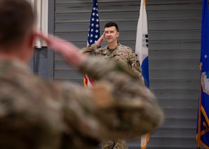 U.S. Air Force Maj. James Phillips, incoming 51st Munitions Squadron commander, renders his first salute during a Change of Command ceremony at Osan Air Base, Republic of Korea, June 17, 2025. Prior to assuming command, Phillips led 300 Airmen across four careers, managed a $61 million stockpile and ensured that the four fighter squadrons at Seymour Johnson Air Force Base were trained, ready and lethal. (U.S. Air Force photo by Staff Sgt. Sarah Williams)