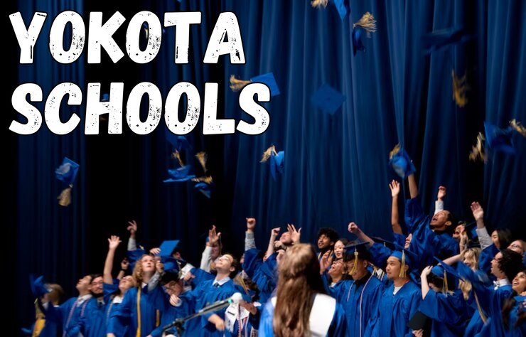 a crowd of students in graduation gowns toss their caps in the air