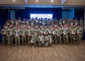 The newest master sergeant selects pose for a group photo during the Master Sergeant Release party at Osan Air Base, Republic of Korea, June 18, 2025. The event recognized their dedication, leadership, and readiness to take on greater responsibilities. (U.S. Air Force photo by Staff Sgt. Sarah Williams)
