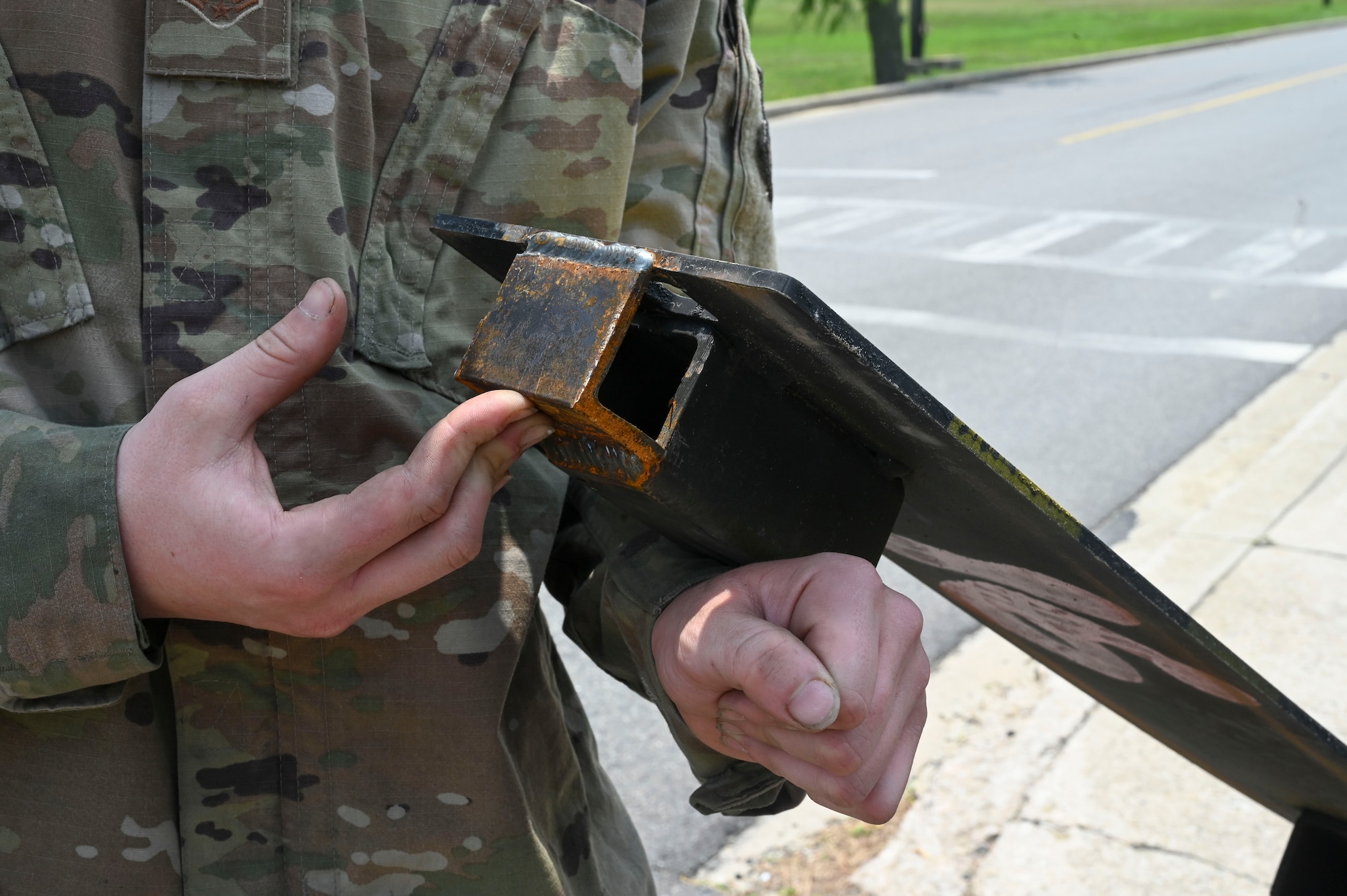 Airman 1st Class Dominic Varoz, 8th Maintenance Squadron aircraft metals technology journeyman, shows the end brackets on a custom built railroad track cover at Kunsan Air Base, Republic of Korea, June 17, 2025.