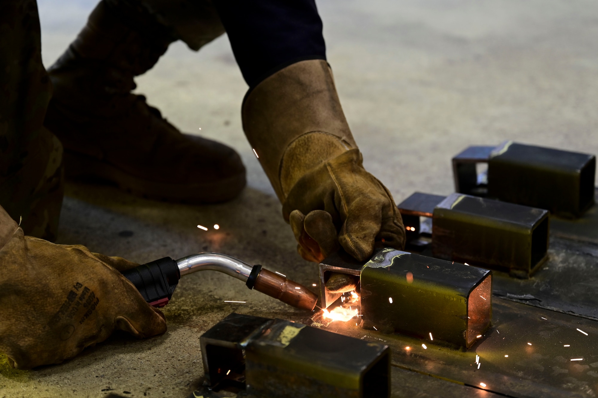 Airman 1st Class Dominic Varoz, 8th Maintenance Squadron aircraft metals technology journeyman, uses a Metal Inert Gas (MIG) welder to weld brackets onto custom built railroad track covers at Kunsan Air Base, Republic of Korea, June 18, 2025.