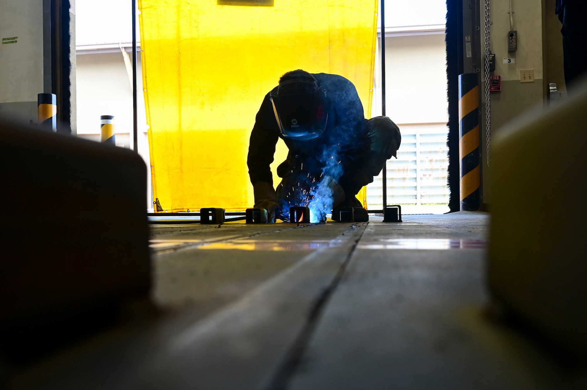 Airman 1st Class Dominic Varoz, 8th Maintenance Squadron aircraft metals technology journeyman, uses a Metal Inert Gas (MIG) welder to weld brackets onto custom built railroad track covers at Kunsan Air Base, Republic of Korea, June 18, 2025.