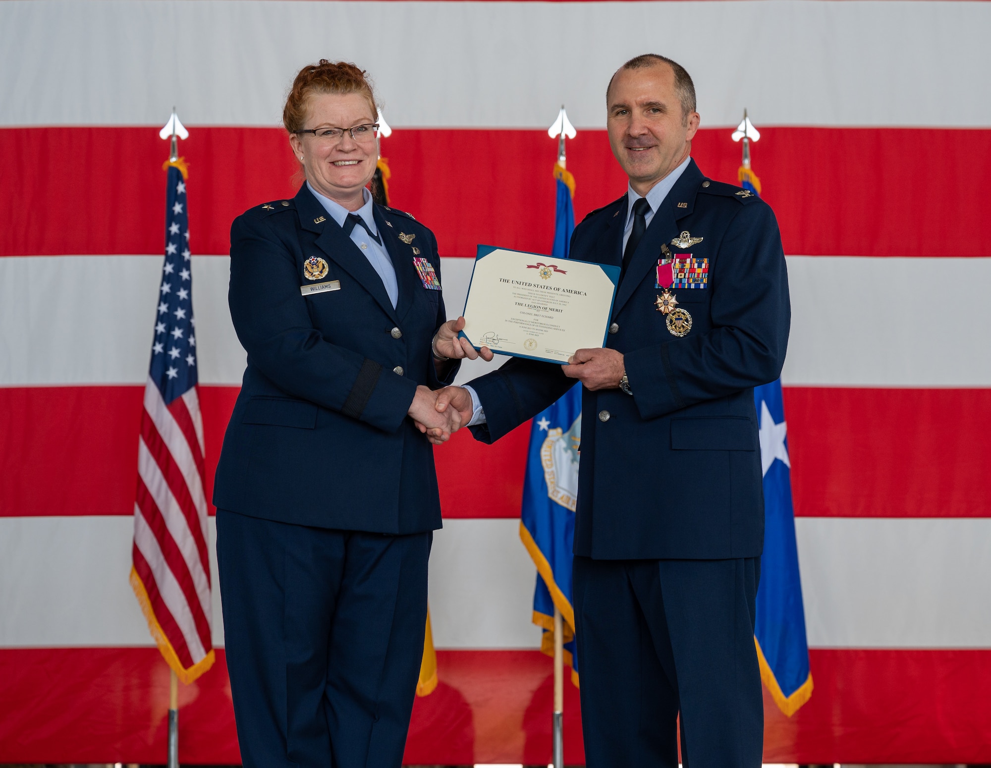 U.S. Air Force Brig. Gen. Adrienne L. Williams, 86th Airlift Wing commander, presents a decoration citation to Col. Bret Echard, 86th Operations Group outgoing commander, during the 86th OG change of command ceremony at Ramstein Air Base, Germany, June 18, 2025. The mission of the 86th OG is to provide resilient, agile power projection, airlift and aeromedical evacuation. (U.S. Air Force photo by Senior Airman Jared Lovett)