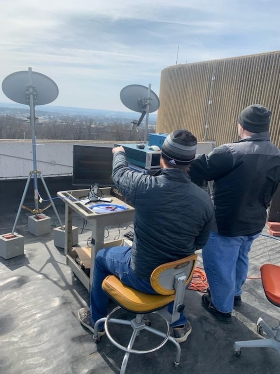 U.S. Naval Research Laboratory (NRL) Electronics Engineer Christian Jones (left), Ph.D. and Johns Hopkins Applied Physics Laboratory Research Engineer Brandon Ravenscroft (right), Ph.D., perform an open-air radar test at the University of Kansas to collect range and velocity characteristics of cars in an intersection in order to test novel waveform techniques.
