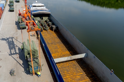 A U.S. Army Light Medium Tactical Vehicle (LMTV) assigned to the 7th Engineer Brigade gets prepped before being lifted by a crane to be loaded on a barge during a barge transportation operation supporting Saber Guardian 25 in Passau, Bayern, Germany, on May 21, 2025. River vessels provide the U.S. Army with a tactical advantage by using waterways instead of standard air, rail, or linehaul methods. (U.S. Army photo by 1st Sgt Jacob Connor)



Demonstrating global deterrence and the U.S. Army’s ability to rapidly deploy U.S.-based combat power in Europe and the Arctic region alongside Allies and partners, DEFENDER 25 brings U.S. troops together with forces from 29 Allied and partner nations to build readiness through large-scale combat training from May 11-June 24, 2025. DEFENDER 25 increases the lethality of the NATO alliance through large-scale tactical training maneuvers and long-range fires, builds unit readiness in a complex joint, multinational environment and leverages host nation capabilities to increase the U.S. Army’s operational reach. During three large-scale combat training exercises—Swift Response, Immediate Response, and Saber Guardian—Ally and partner forces integrate and expand multi-domain operations capability, demonstrating combined command and control structures and readiness to respond to crisis and conflict.