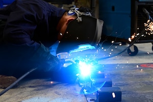 Airman 1st Class Jayden Bolo, 8th Maintenance Squadron aircraft metals technology journeyman, uses a Metal Inert Gas (MIG) welder to weld brackets onto custom built railroad track covers at Kunsan Air Base, Republic of Korea, June 18, 2025.