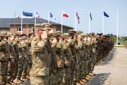 U.S. Soldiers, supporting Task Force Voit and NATO Allies, salute for the national anthem during an Estonian-led award ceremony on Camp Tapa, Estonia, June 4, 2025. U.S. Soldiers, along with NATO Allies, received the NATO Kaitsel "Defender" Medal for their contribution to the NATO Enhanced Forward Presence mission in Estonia. (U.S. Army photo by Sgt. Austin Steinborn)