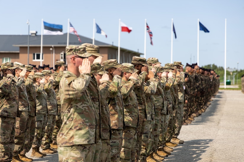 U.S. Soldiers, supporting Task Force Voit and NATO Allies, salute for the national anthem during an Estonian-led award ceremony on Camp Tapa, Estonia, June 4, 2025. U.S. Soldiers, along with NATO Allies, received the NATO Kaitsel "Defender" Medal for their contribution to the NATO Enhanced Forward Presence mission in Estonia. (U.S. Army photo by Sgt. Austin Steinborn)