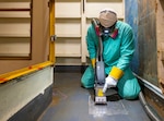 Chase Absher, painter, Shop 71, Painters, Blasters, Tilesetters, works with a laser ablation tool aboard USS Ronald Reagan (CVN 76), May 21, 2025, at Puget Sound Naval Shipyard & Intermediate Maintenance Facility in Bremerton, Washington. (U.S. Navy photo by Wendy Hallmark)