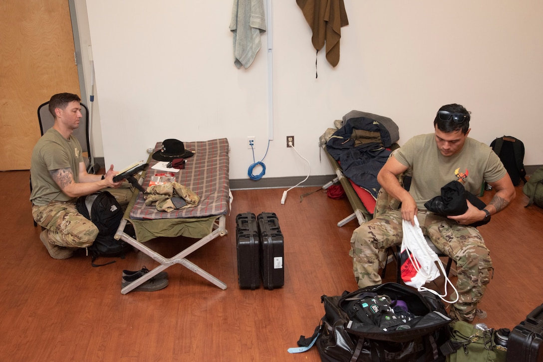 U.S. Army Capt. Casey Clark and Chief Warrant Officer 2 Michael Davis, 82nd Combat Aviation Brigade AH-64 Apache helicopter pilots, settle in at Joint Base Andrews, Md., June 11, 2025. More than 250 Soldiers used the Community Commons and fitness centers as living quarters ahead of their participation in the Army’s 250th birthday in Washington, D.C.