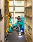 Ladante Taylor, supervisor, and Elizabeth Adapon, painter, Shop 71, Painters, Blasters, Tilesetters, use a laser ablation tool to remove paint coating and corrosion aboard USS Ronald Reagan (CVN 76), May 22, 2025, at Puget Sound Naval Shipyard & Intermediate Maintenance Facility in Bremerton, Washington. (U.S. Navy photo by Wendy Hallmark)