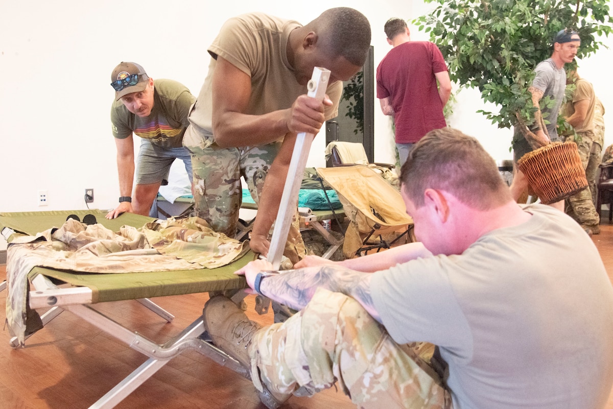 U.S. Soldiers with the 82nd Combat Aviation Brigade from Fort Bragg, N.C., set up cots at Joint Base Andrews, MD., June 11, 2025. More than 250 Soldiers settled into the fitness centers and Community Commons at Andrews ahead of the Army’s 250th Birthday Festival and Parade in Washington, D.C.