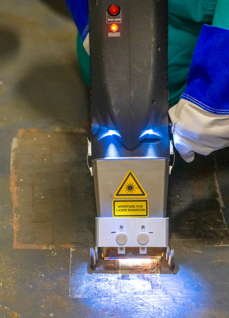 Laser ablation, a widely-used commercial process for removing coatings and corrosion, is undergoing testing on USS Ronald Reagan (CVN 76) surfaces for shipyard use. Laser ablation has the potential to be a cleaner, quieter process with less vibration. (U.S. Navy photo by Wendy Hallmark)