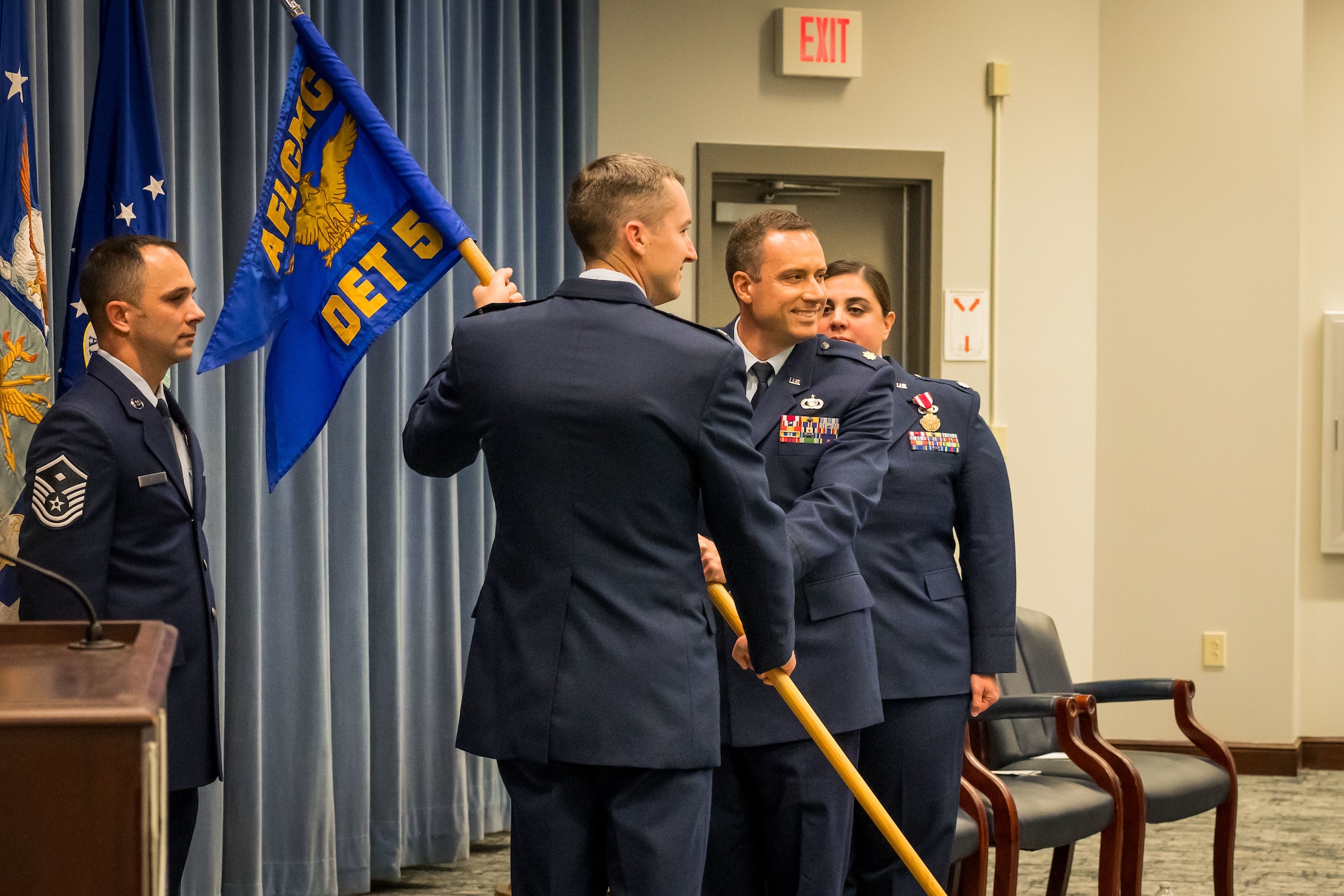 Col. Chadwick Steipp, Deputy Commander, AFLCMC, passes the Detachment 5 guidon to Maj. Austin Myers, symbolizing Myers’ official assumption of