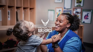 A woman plays with a child.