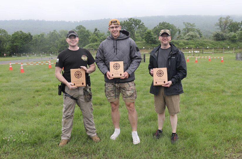 From left, U.S. Army Sgt. 1st Class Ben Harris, third place, Sgt. Matviy Korytnyuk, first place, and Col. Kevin D. Potts, second place, pose for a photo following the 2025 FTIG 2-Gun Steel Shoot at Fort Indiantown Gap, Pennsylvania, June 14, 2025.