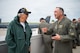 Gary Lee speaks with Col. Jesse Lamarand on a rooftop. B-52H Stratofortress aircraft is visible in the background.