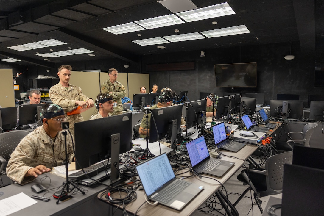 U.S. Marines with 3rd Light Armored Reconnaissance Battalion, 1st Marine Division, I Marine Expeditionary Force, participate in a simulated training at the Battle Simulation Center, Marine Corps Air Ground Combat Center, Twentynine Palms, California, April 8, 2025. The Defense Advanced Research Project Agency’s partnership with MAGTFTC’s BSC and 1st MARDIV units represents a long-term investment in gaining a strategic edge by developing performance metrics for Fire Support Team training and enhancing systems like the Joint Terminal Attack Controller Virtual Trainer. (U.S. Marine Corps photo by Cpl. Anna Higman)