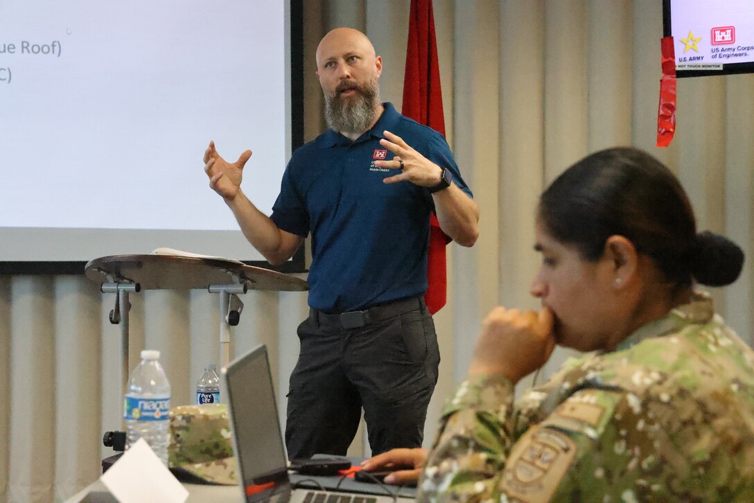 Picture of a man giving a presentation.