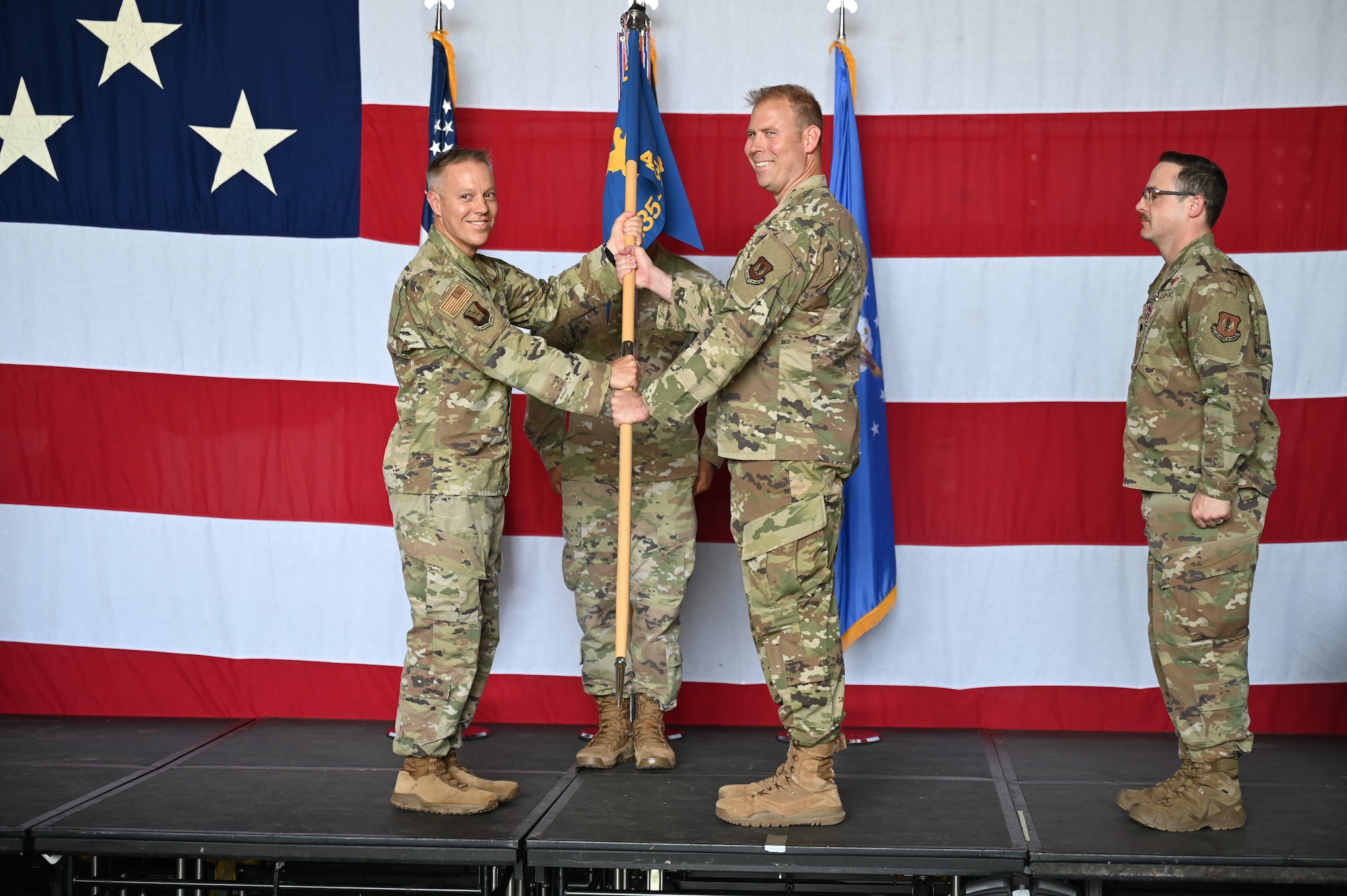 Four men participate in a change of command