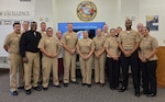 Center, from left to right, Kathryn Mercer, the Naval Medical Forces Development Command’s chief of staff; Rear Adm. Walter Brafford, NMFDC commander; Command Master Chief Veronica Brittenum, NMFDC senior enlisted leader; and Capt. Sharon House, NMFDC deputy commander, pose for a photo with the command's Hospital Corpsman during the 127th U.S. Navy Hospital Corps birthday celebration held on Joint Base San Antonio-Fort Sam Houston, Texas June 17, 2025. The Hospital Corps consists of more than 30,000 active and reserve Sailors specializing in 40 medical fields. They serve globally in military medical facilities and support both the Navy and Marine Corps, and joint operations. (U.S. Navy photo by Petty Officer 2nd Class Rafie Solis).