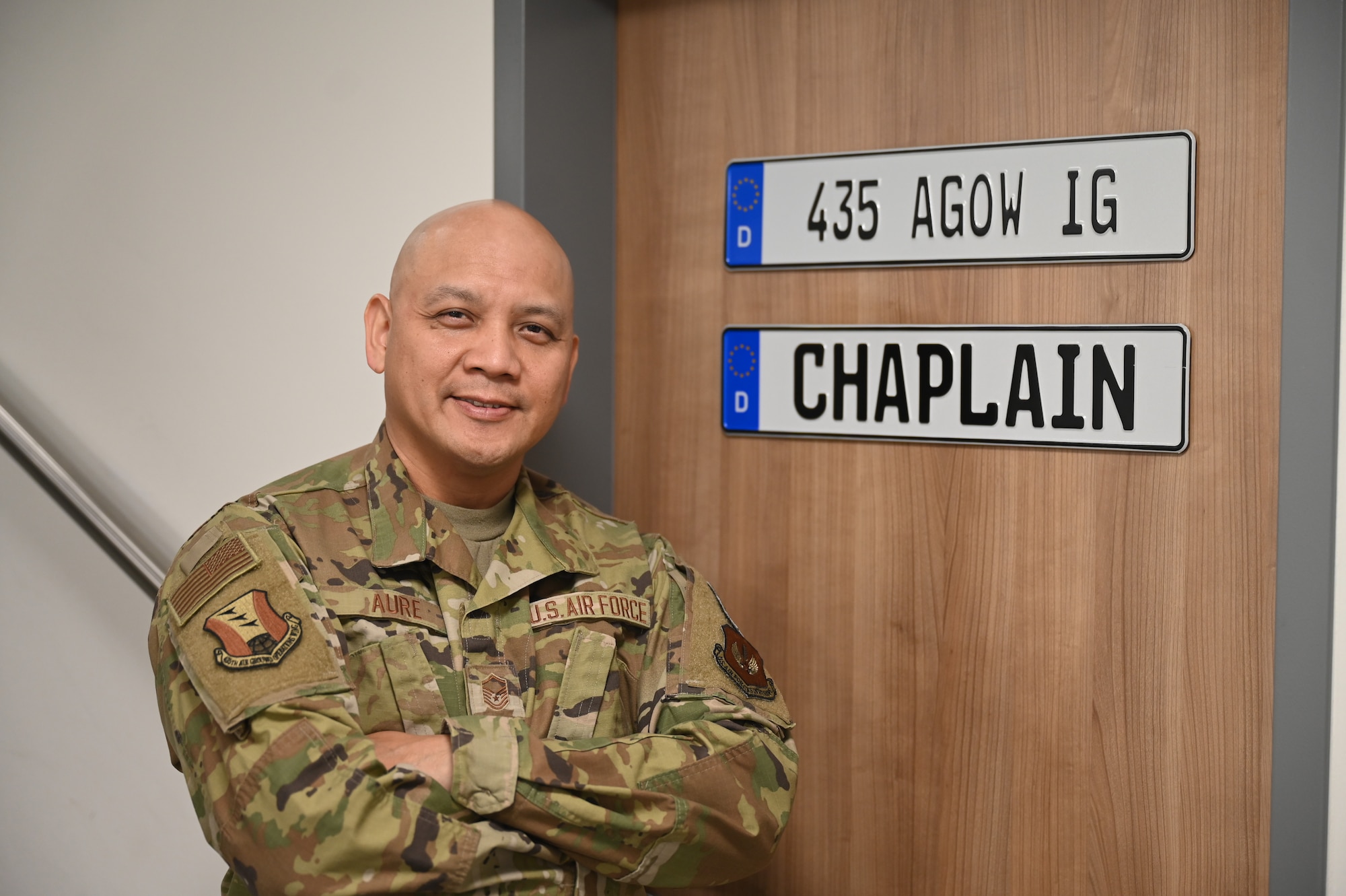 A man stands in front of a door with signs