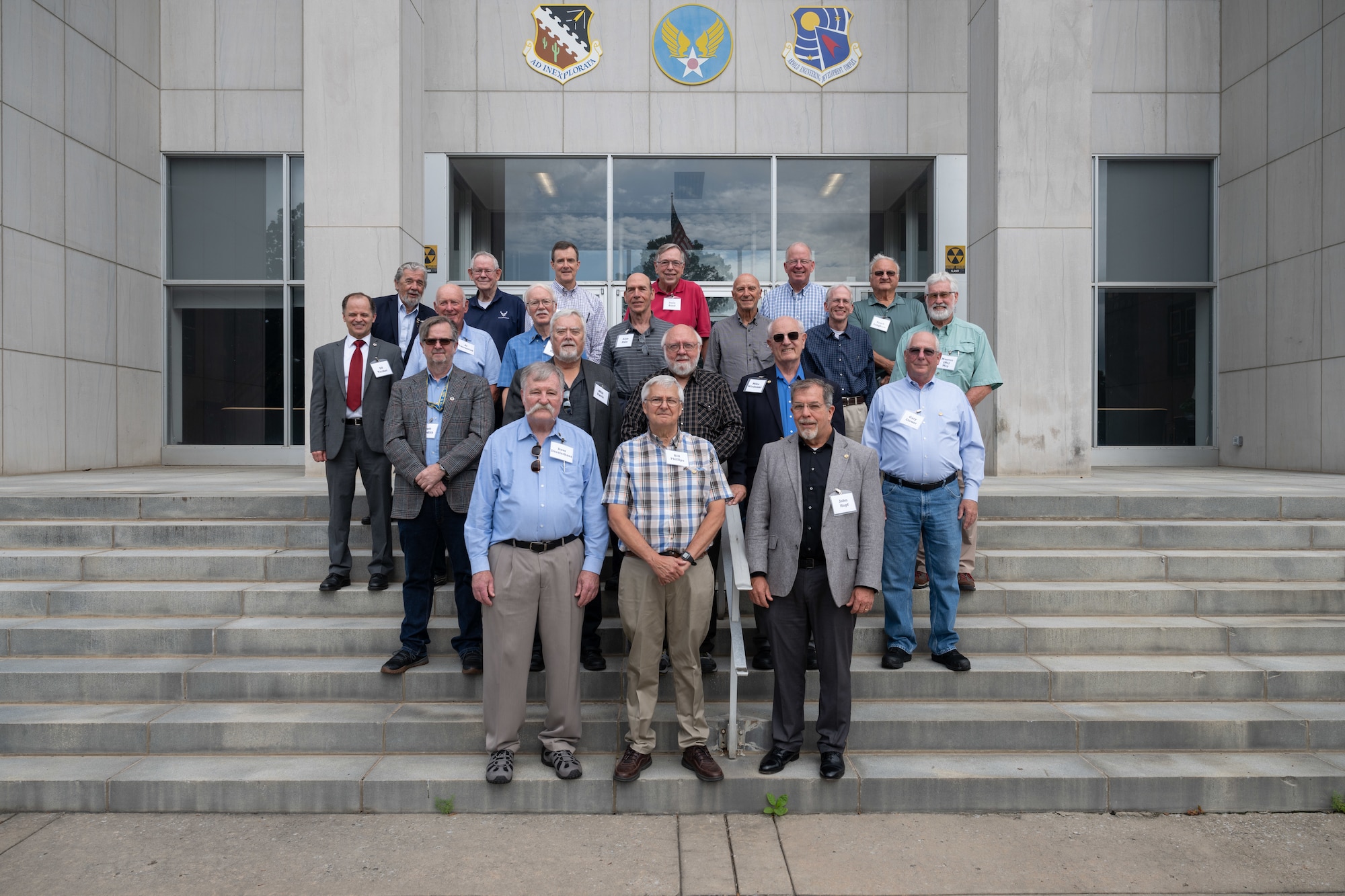 Arnold Engineering Development Complex Fellows gather for a photo on the steps of the Administration and Engineering Building at Arnold Air Force Base, Tenn., during AEDC Fellows Day, June 17, 2025. AEDC is headquartered at Arnold AFB. Pictured in the front row, from left, are newly selected AEDC Fellows Dave Duesterhaus, Bill Phillips and John Hopf. The AEDC Fellows program recognizes AEDC personnel who have made substantial and exceptionally distinguished contributions to the nation’s aerospace ground testing capability. Newly selected AEDC Fellows are traditionally honored annually on or around June 25 to coincide with the birthday of Gen. Henry “Hap” Arnold and anniversary of the June 1951 dedication of AEDC in Gen. Arnold’s honor. (U.S. Air Force photo by Keith Thornburgh)