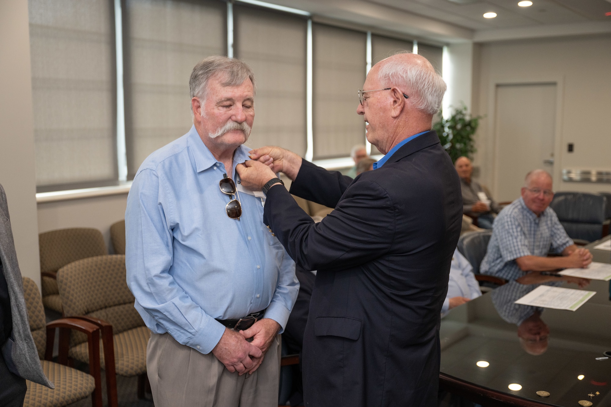 Newly selected Arnold Engineering Development Complex Fellow Dave Duesterhaus, left, receives his AEDC Fellows lapel pin from Maj. Gen. (Ret.) Mike Wiedemer with the Arnold Community Council during AEDC Fellows Day June 17, 2025, at Arnold Air Force Base, Tenn. AEDC is headquartered at Arnold AFB. Duesterhaus was one of the three AEDC retirees selected by the ACC for induction into the Fellows program this year. The AEDC Fellows program recognizes AEDC personnel who have made substantial and exceptionally distinguished contributions to the nation’s aerospace ground testing capability. Newly selected AEDC Fellows are traditionally honored annually on or around June 25 to coincide with the birthday of Gen. Henry “Hap” Arnold and anniversary of the June 1951 dedication of AEDC in Gen. Arnold’s honor. (U.S. Air Force photo by Keith Thornburgh)