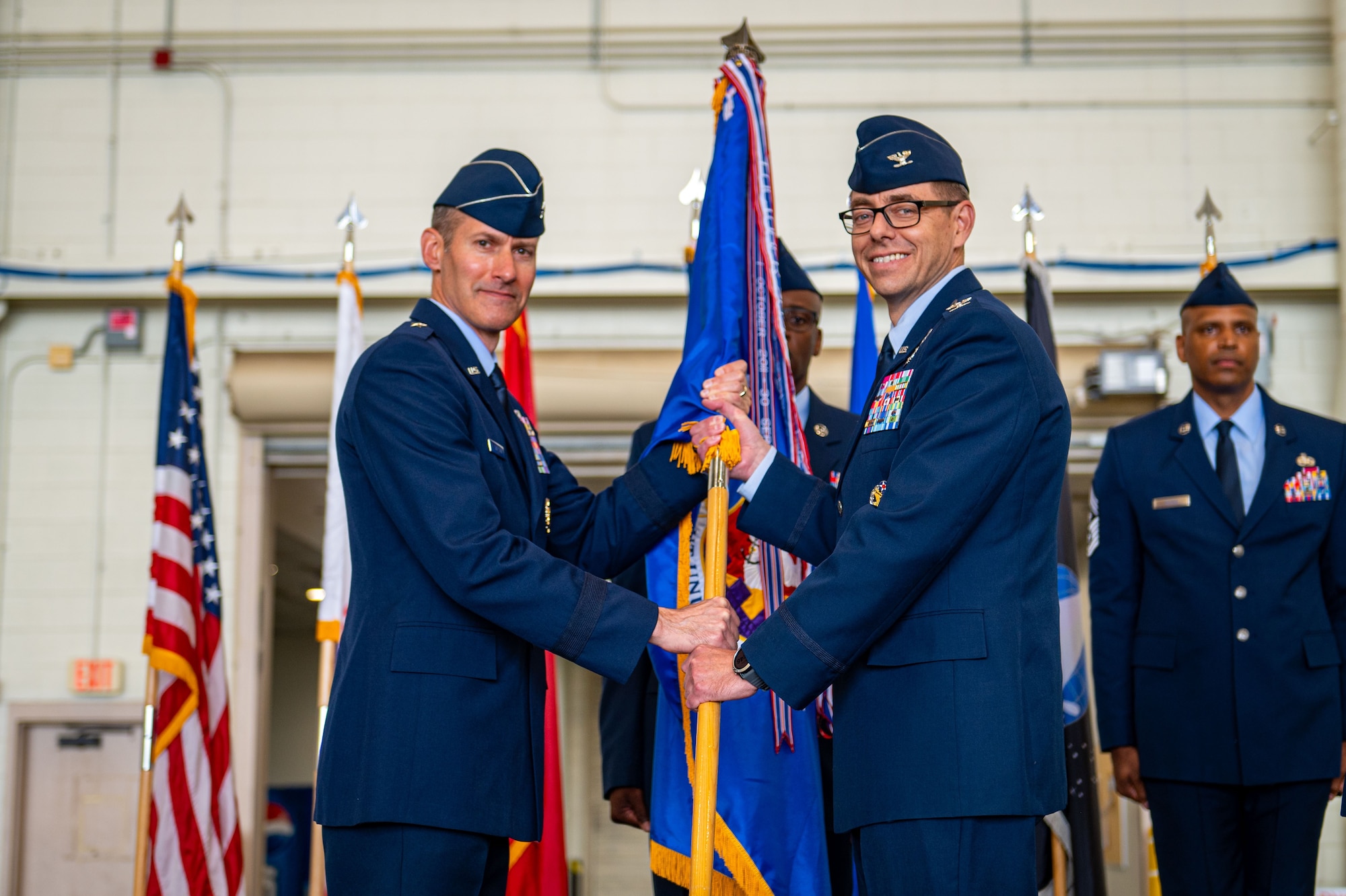 U.S. Air Force Brig. Gen. Stephen Snelson, U.S. Air Force Expeditionary Center commander, passes the guidon to Col. Michael Stefanovic, who assumed command of Joint Base McGuire-Dix Lakehurst and the 87th Air Base Wing during a change of command ceremony at JB MDL, N.J., June 17, 2025.
