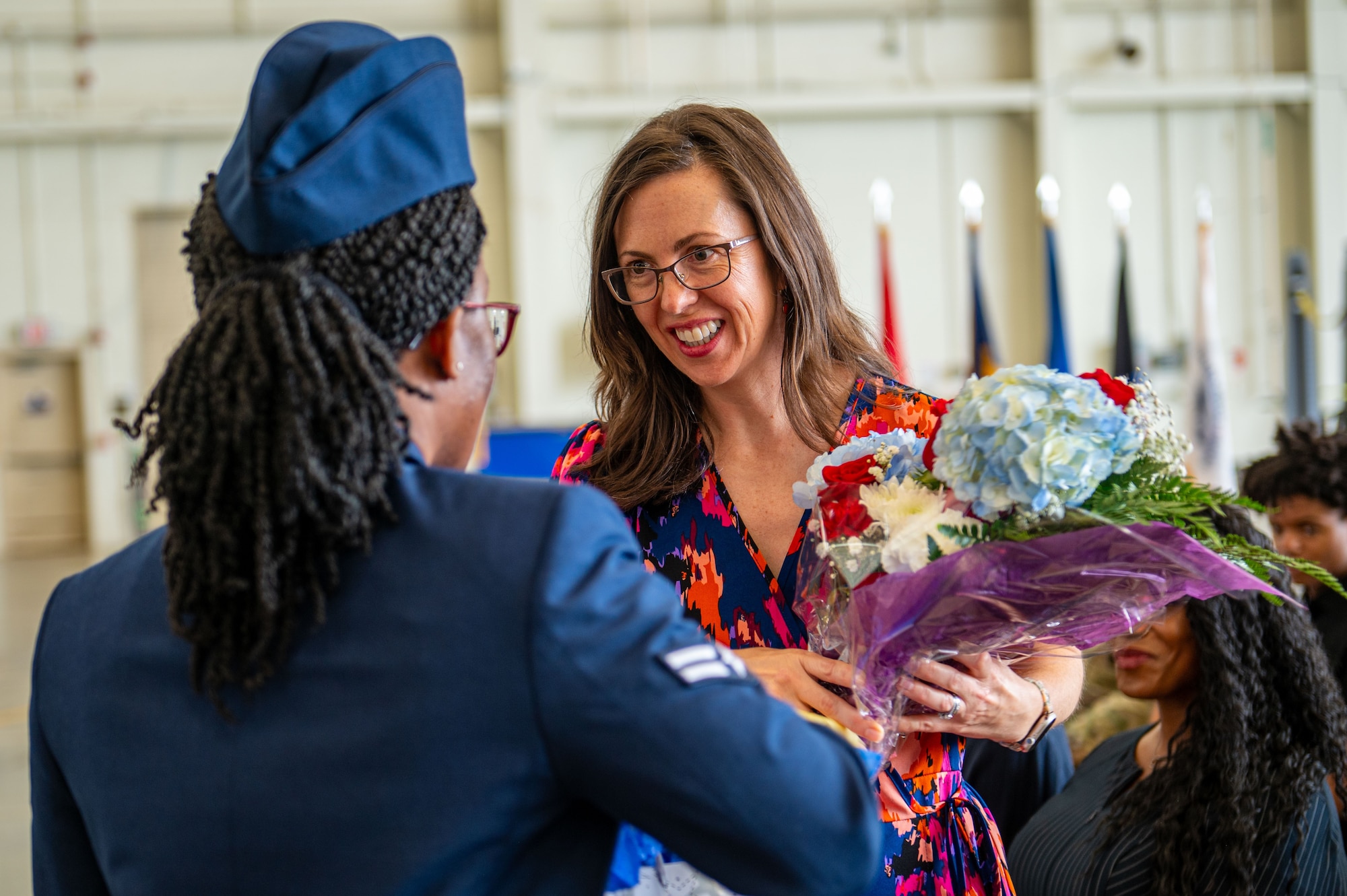 Megan Stefanovic, wife of U.S. Air Force Col. Michael Stefanovic, Joint Base McGuire-Dix-Lakehurst and the 87th Air Base Wing commander, is gifted flowers during the change of command ceremony at JB MDL, N.J., June 17, 2025.