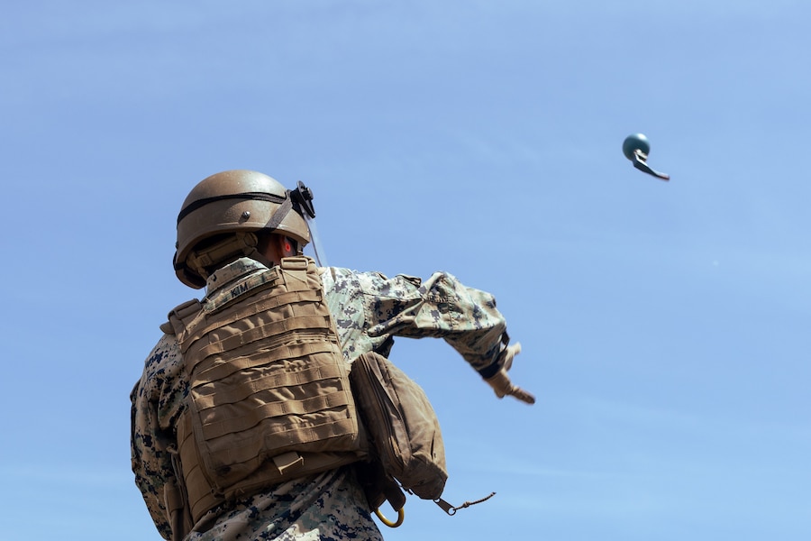 U.S. Marine Corps Staff Sgt. Gabriel Wall, a logistics and embarkation specialist with Combat Logistic Battalion 26, 22nd Marine Expeditionary Unit, throws a Stinger 32 caliber rubber ball grenade during a non-lethal weapons course at Marine Corps Base Stone Bay, May 1, 2025. The non-lethal weapons course teaches students about weapons that are explicitly designed and primarily employed to incapacitate personnel or materiel while minimizing fatalities, permanent injury to personnel, and undesired damage to property and the environment. (U.S. Marine Corps photo illustration by Lance Cpl. Kyle Baskin) (Double exposure photo made in-camera with a Canon EOS R5)