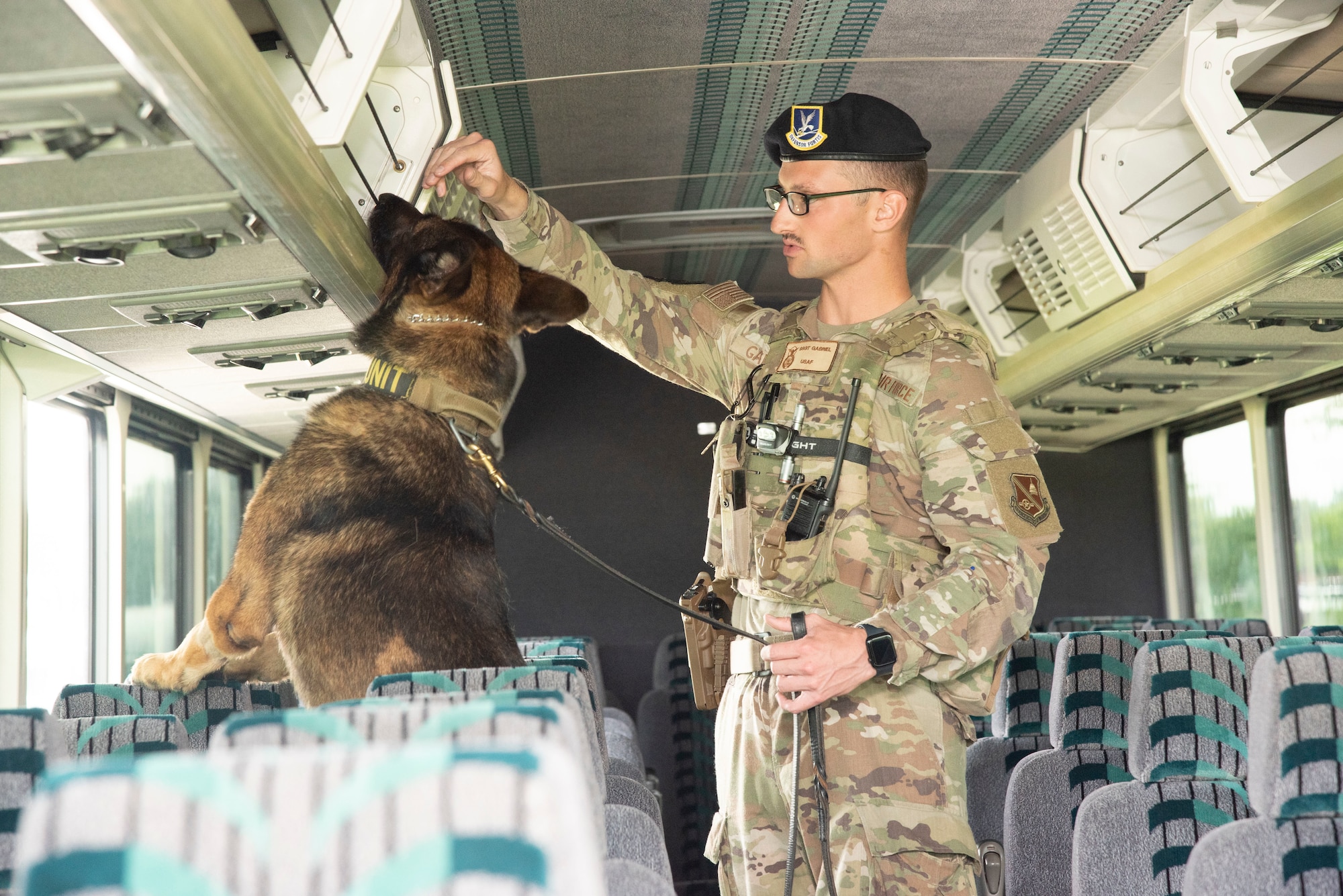 U.S. Air Force Staff Sgt. Colton M. Gabriel, 316th Security Support Squadron, and his working dog, Lucky, secure a bus June 10, 2025, at Joint Base Andrews, Md. The bus was being used to transport U.S. Army Soldiers arriving at Andrews to participate in the Army’s 250th Birthday Festival and Parade June 14 in Washington, D.C.