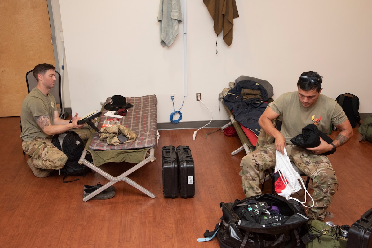 U.S. Army Capt. Casey Clark and Chief Warrant Officer 2 Michael Davis, 82nd Combat Aviation Brigade AH-64 Apache helicopter pilots, settle in at Joint Base Andrews, Md., June 11, 2025. More than 250 Soldiers used the Community Commons and fitness centers as living quarters ahead of their participation in the Army’s 250th birthday in Washington, D.C.