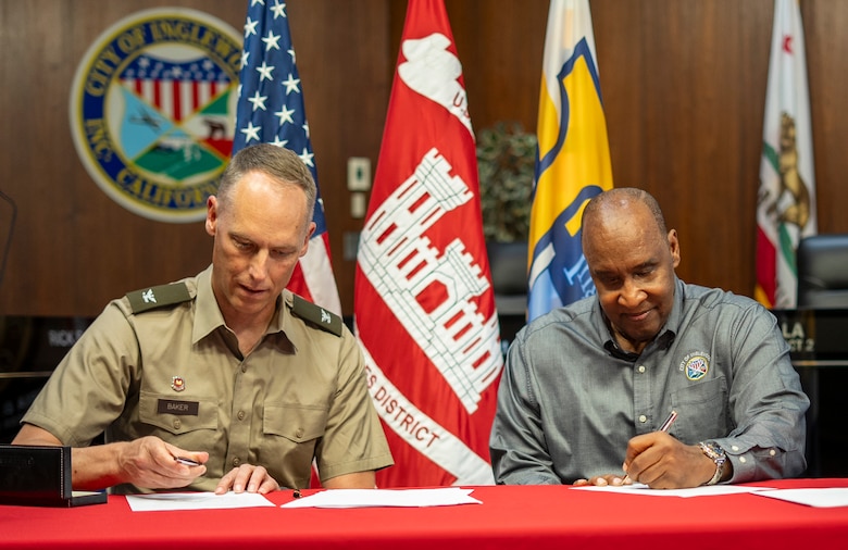 Col. Andrew Baker, commander of the U.S. Army Corps of Engineers Los Angeles District, left, and Inglewood Mayor James Butts Jr. sign a Section 219 project agreement June 13 at Inglewood City Hall in Inglewood, California. The agreement supports the design and construction of the Morningside Reservoir, aimed at improving emergency and fire water storage capacity.