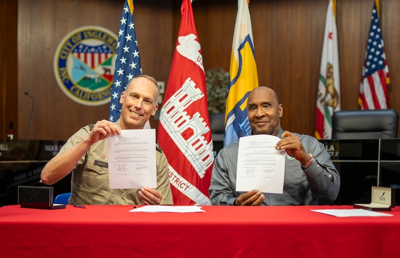 Col. Andrew Baker, commander of the U.S. Army Corps of Engineers Los Angeles District, and Inglewood Mayor James Butts Jr. hold up signed Section 219 Program project agreement documents during a ceremony held June 13 at Inglewood City Hall.