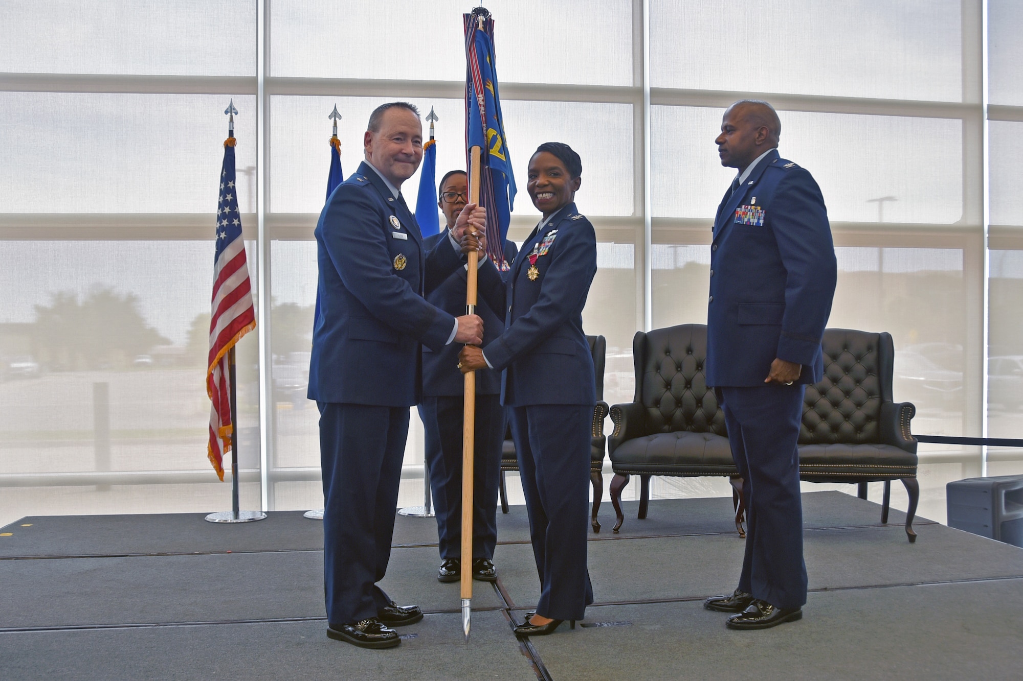 Outgoing 82d Medical Group commander, Col. Sarah Evans, hands the guidon to 82d Training Wing Commander Brig. Gen. Paul Filcek