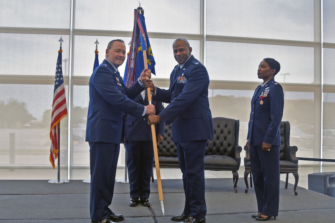 Col. Franklin Porcil takes the guidon from 82d Training Wing Commander Brig. Gen. Paul Filcek during the 82d Medical Group change of command ceremony
