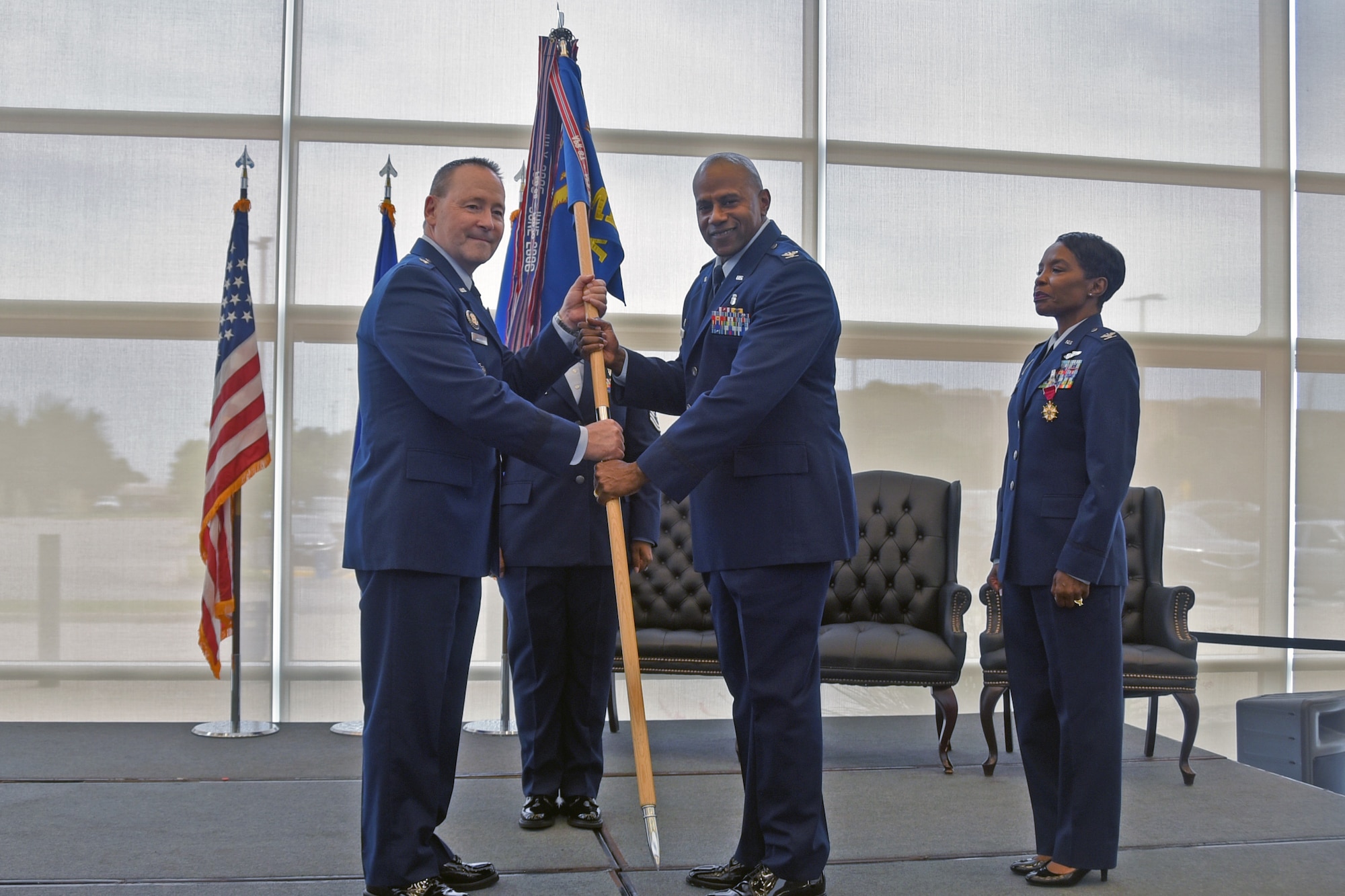 Col. Franklin Porcil takes the guidon from 82d Training Wing Commander Brig. Gen. Paul Filcek during the 82d Medical Group change of command ceremony