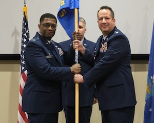 photo of US Airmen holding a unit flag