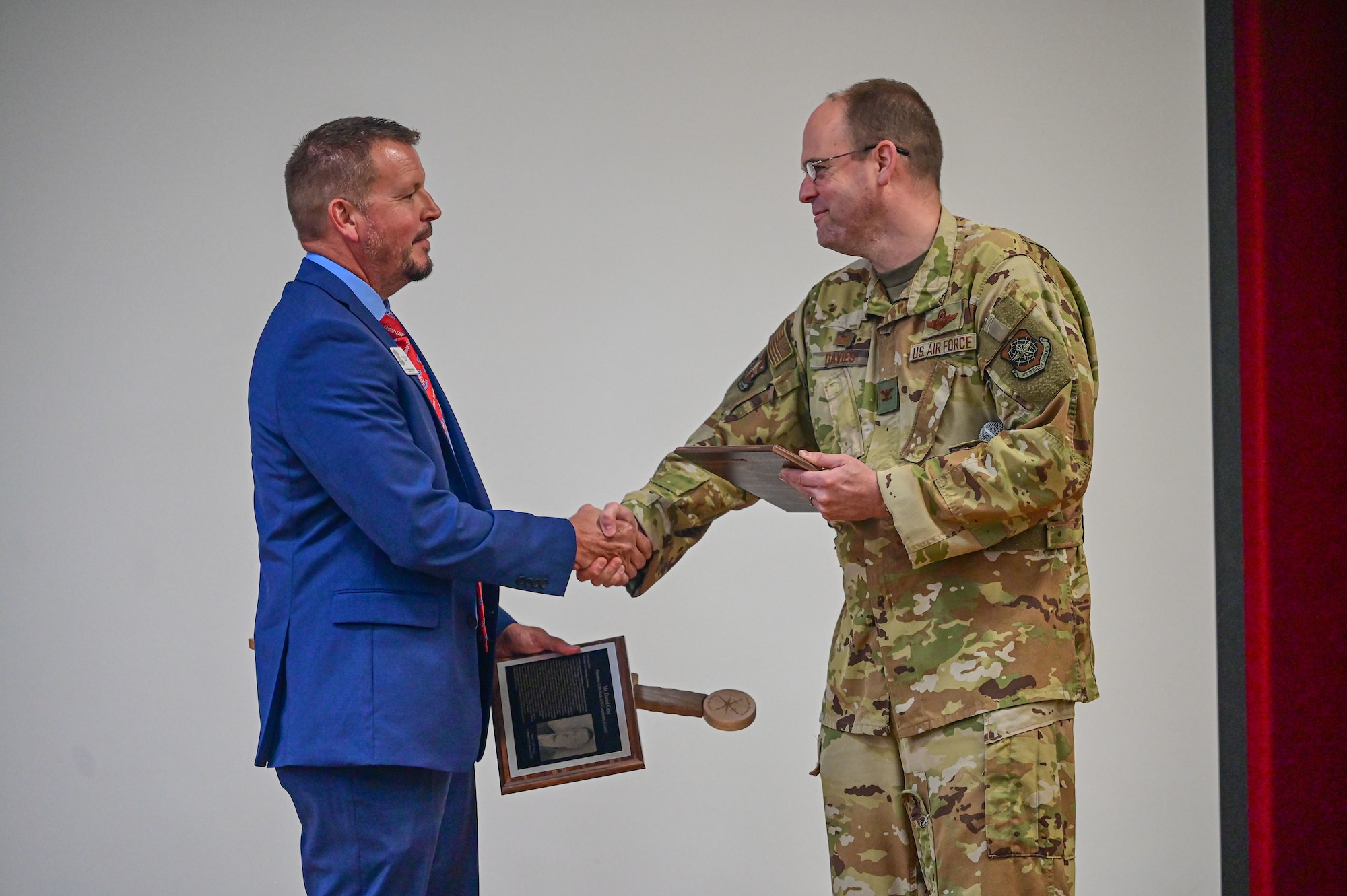 Daniel Gray, Jacksonville Community Council president, is presented with a Cornerstone Award by Col. Denny Davies, 19th Airlift Wing and installation commander, at the Jacksonville Community Center, Arkansas, June 17, 2025.