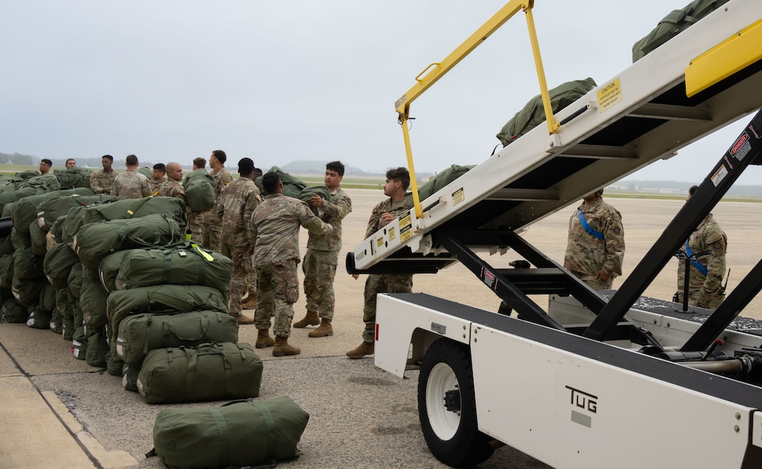 Soldiers assigned to the 1st Cavalry Division load luggage onto an aircraft.