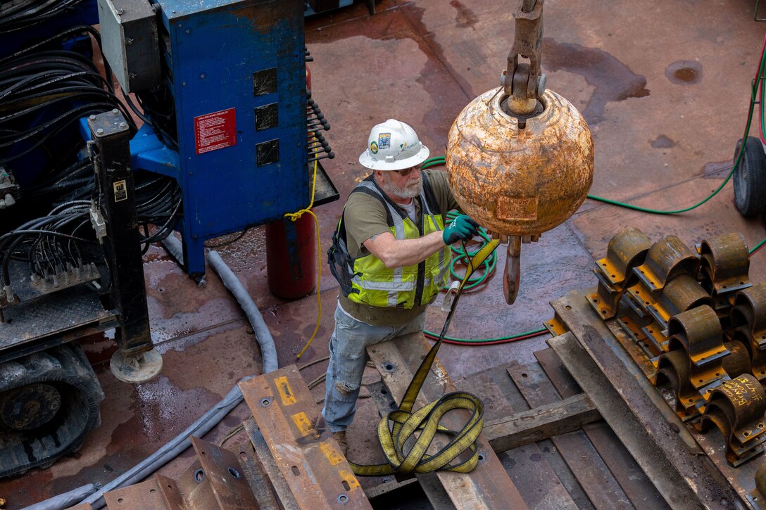 Construction crews work at a navigational lock along a river.