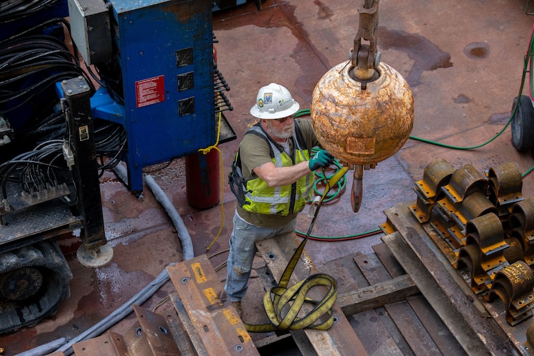 Construction crews work at a navigational lock along a river.