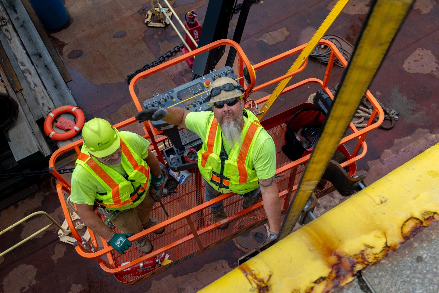 Construction crews work at a navigational lock along a river.
