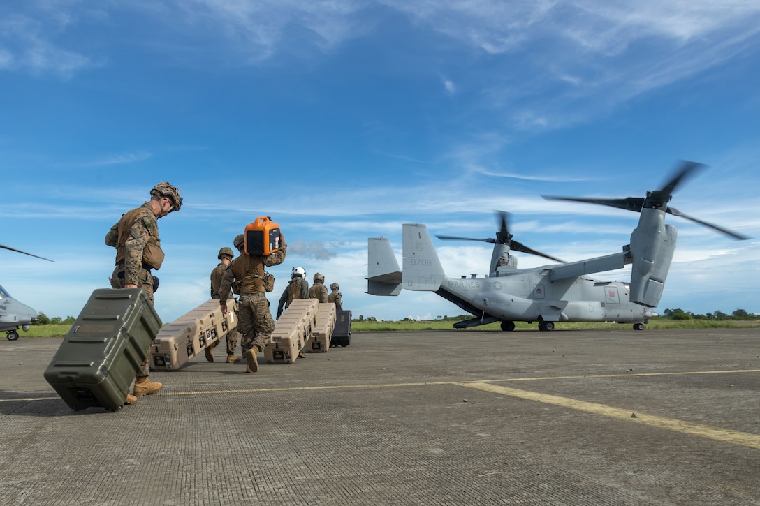 U.S. Marines with 3d Littoral Combat Team, 3d Marine Littoral Regiment, 3d Marine Division, prepare to load gear into a U.S. Marine Corps MV-22B Osprey assigned to Marine Medium Tiltrotor Squadron (VMM) 364, Marine Aircraft Group 39, 3rd Marine Aircraft Wing, during KAMANDAG 9 at Lal-lo Airport, Cagayan, Philippines, May 27, 2025. KAMANDAG is an annual Philippine Marine Corps and U.S. Marine Corps-led exercise aimed at enhancing the Armed Forces of the Philippines’ defense and ex capabilities by providing valuable training in combined operations with foreign militaries in the advancement of a Free and Open Indo-Pacific. (U.S. Marine Corps photo by Staff Sgt. Luc Boatman)