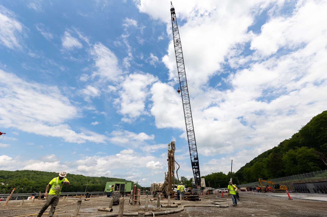 Construction workers make groundbreaking progress at a construction site at a navigational lock along a river.