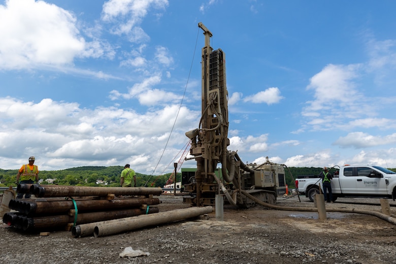 Construction workers make groundbreaking progress at a construction site at a navigational lock along a river.