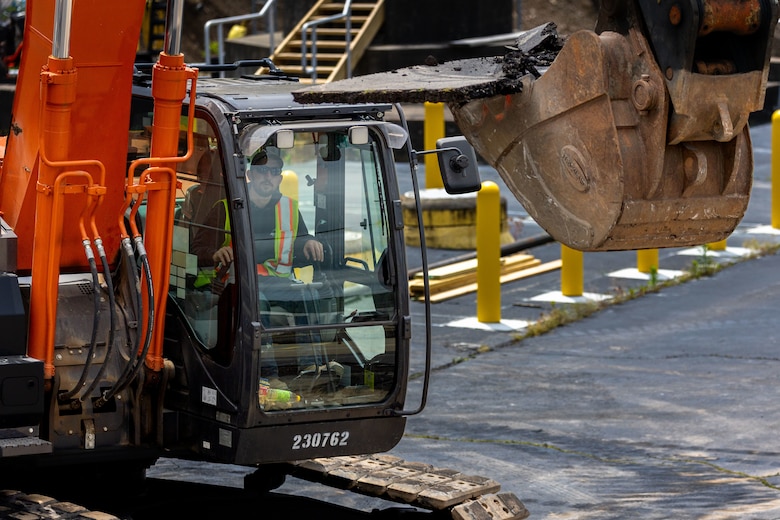 Construction workers make groundbreaking progress at a construction site at a navigational lock along a river.
